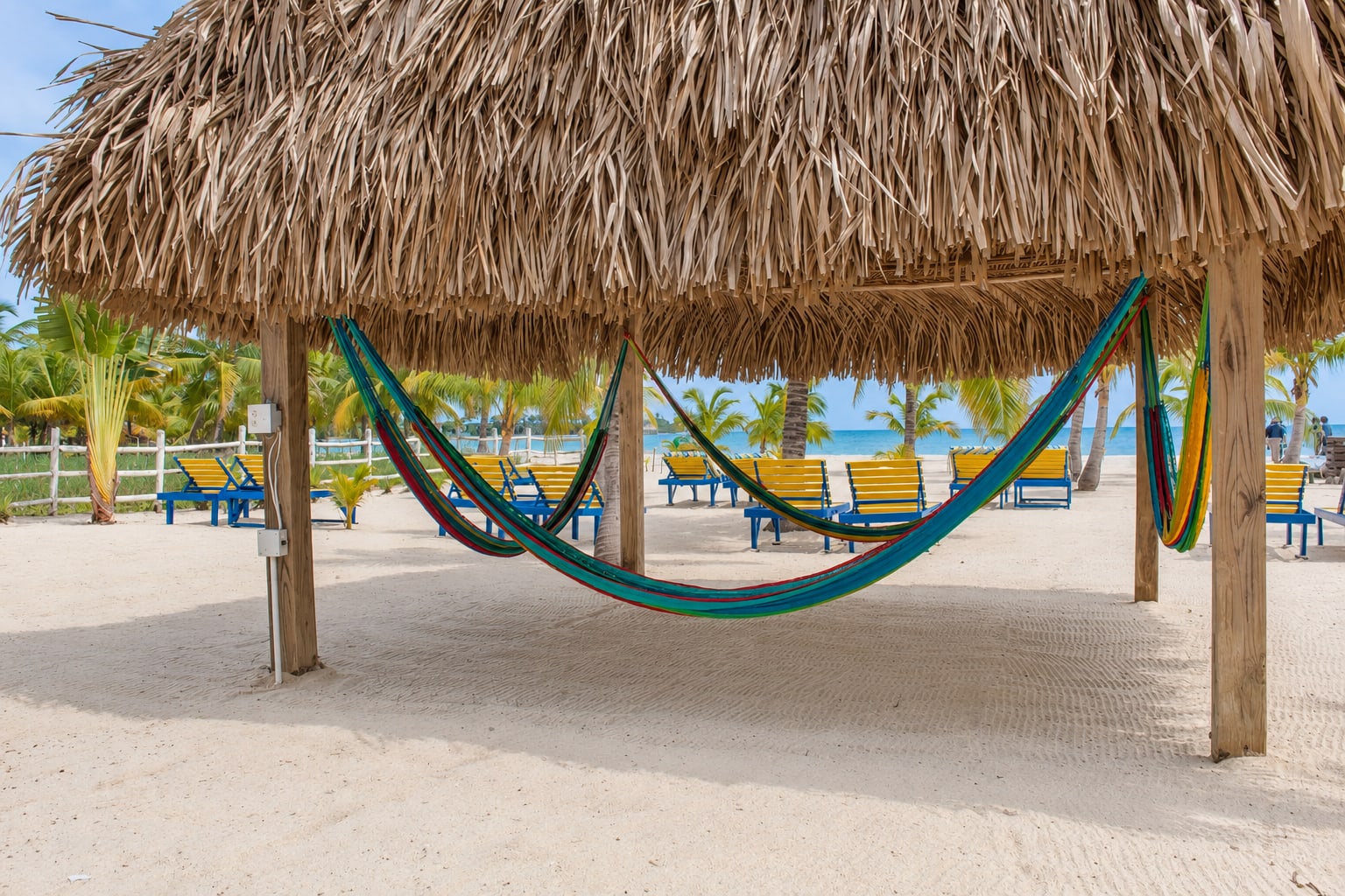 Hammocks beneath a shaded Casa Palma palapa